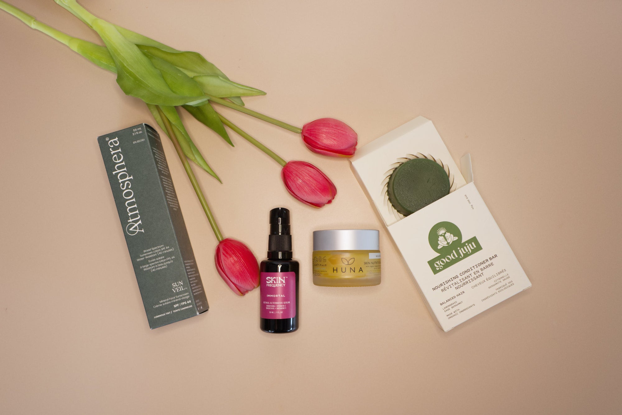 Cosmetic products with tulips on a beige background